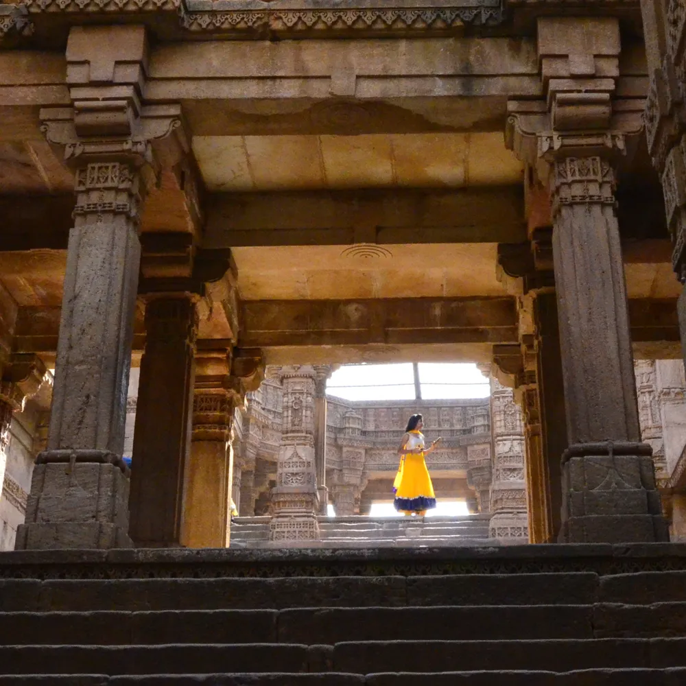 Looking through carved stone columns and stairways inside Adalaj Stepwell