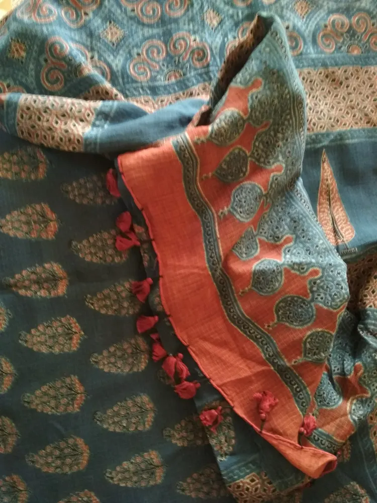 Folded Ajrakh textile with blue red black and white geometric block-printed patterns