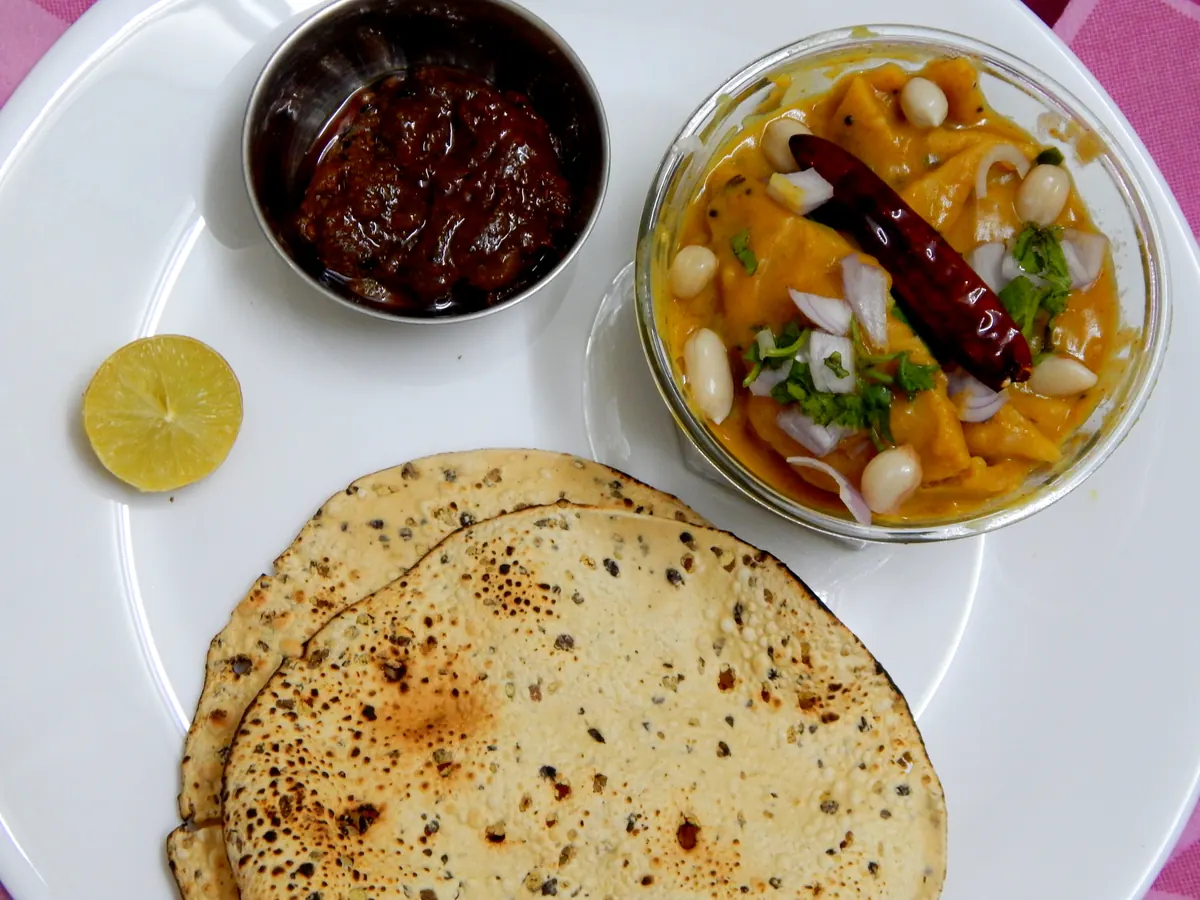 Bowl of Gujarati dal dhokli with wheat pieces in lentil gravy
