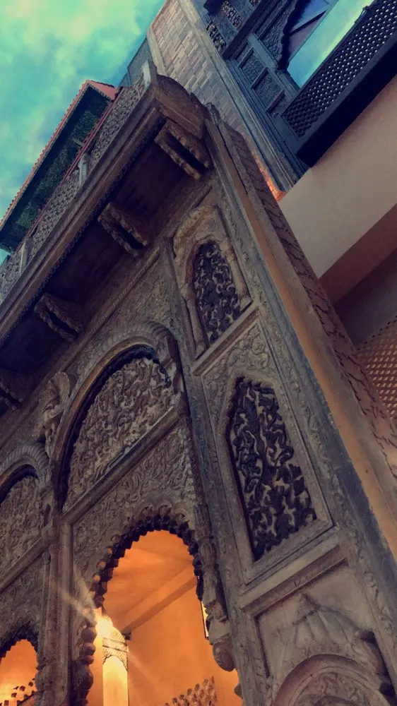 Ornately carved entrance within a traditional Ahmedabad pol streetscape